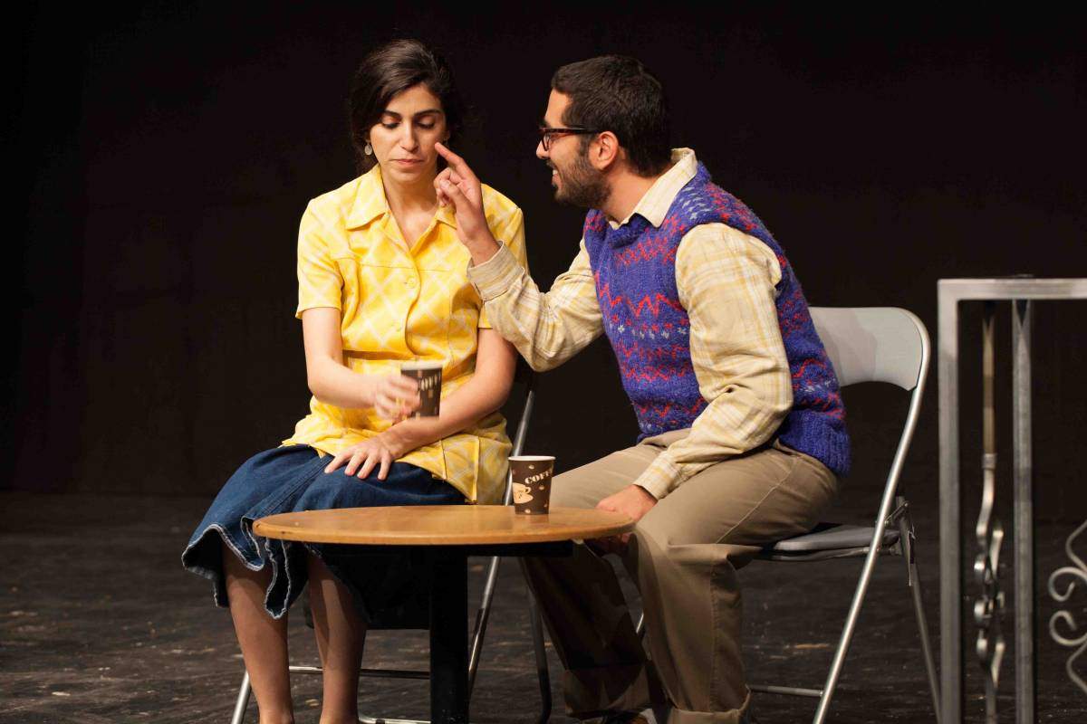 Tachtich and Trude meet romantically in a neighborhood café. That meeting will end when Krum makes his entrance.) Reut Nuri (Truda) and Amir Mandelbaum (Takhtikh) 