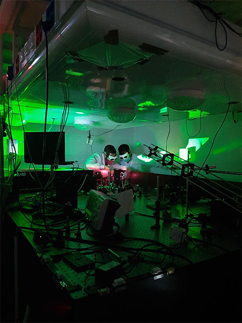 Dr. Omer Kneller (left) and Chen Mor direct a laser beam before it enters the experimental setup. The experiment required a powerful laser beam that could produce exceptionally short, attosecond light pulses. Photo: Noa Yaffe